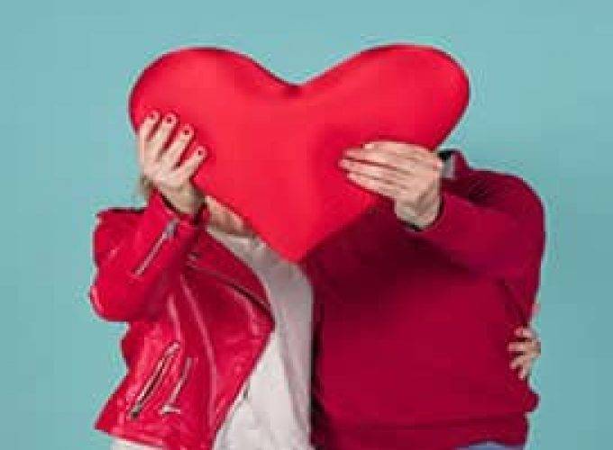 couple holding big red heart